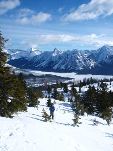 Ben hiking up with beautiful mountains behind