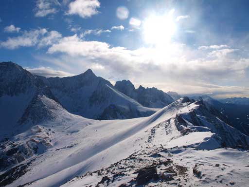 Sun glare over Opal Range peaks. The high one is Mt. Evan-Thomas. Behind it is Mt. Packenham