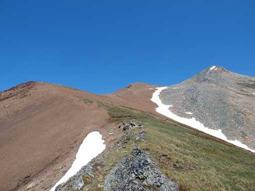 Above the gully and the big grassy slope. Now I'm aiming for the saddle between two brown bumps