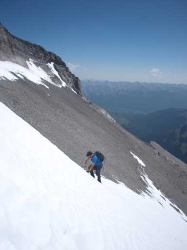 Clayton kicking step up the steep snow. This is the only part that we need an axe.