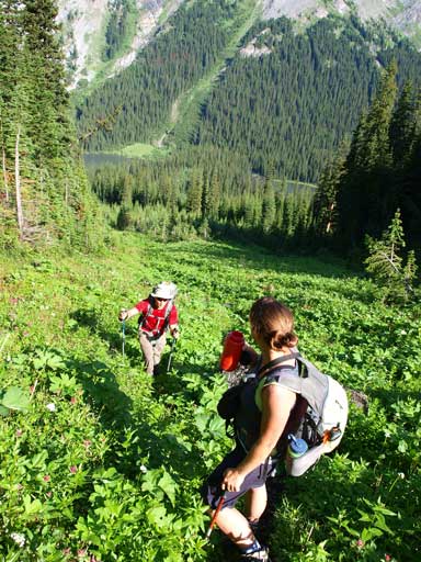 Shuan and Andrea hiking up the vegetated slope.