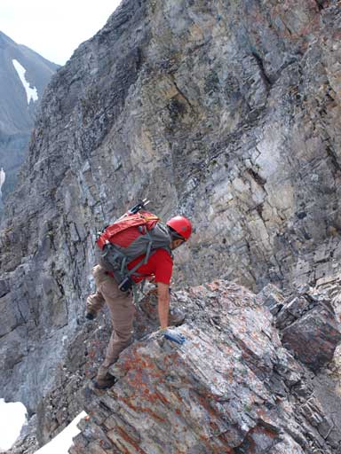 Shuan challenging an exposed, but unnecessary step. The normal route goes below the ridge crest on climber's right.