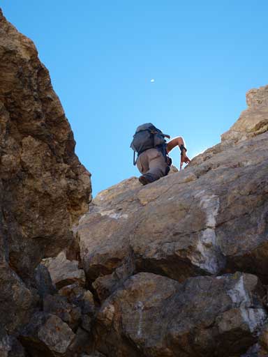 Andrea down-climbing the crux
