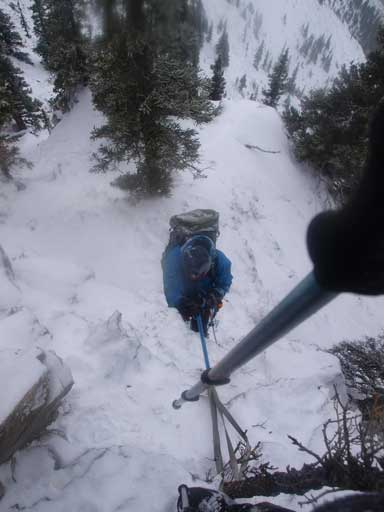 Ben climbing up the rope at the crux