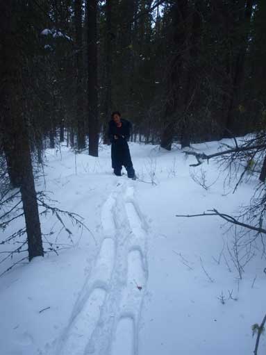 Mom following my tracks up the forested slope