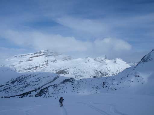 Mom trudging up the slope, with big views behind.