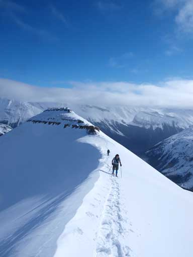 Going up some interesting snow terrain. False summit behind