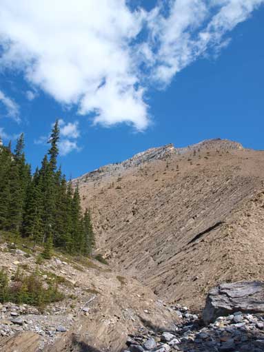 Finally at the base of orange slope. The route goes up tedious scree to the right of this photo.