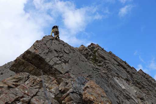 Me challenging up the direct slab route. Photo by Ben N