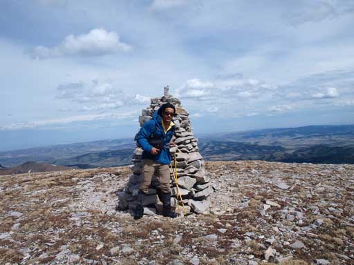 Me with the big cairn on first summit. As you can see, it was extremely windy. We could barely take this shot