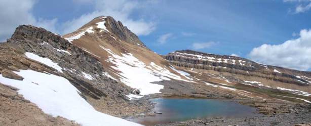 The route goes on left skyline overcomes the obvious rock band. The tarn is unnamed
