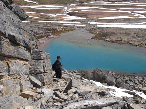 Dad scrambling through the rock band, with the unnamed tarn below