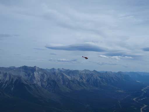 A helicopter hovering around. Fairholme Range behind