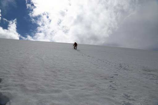 Me kicking step up the snow slope just before the summit. Photo by Ben N