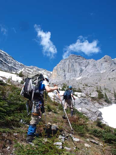 Ben and Ken hiking up some vegetated slope
