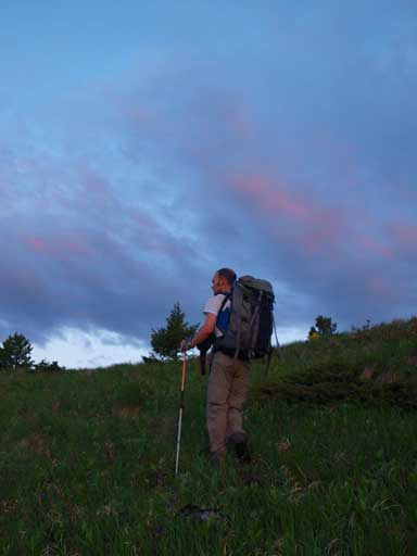 Ben hiking up the grassy slope