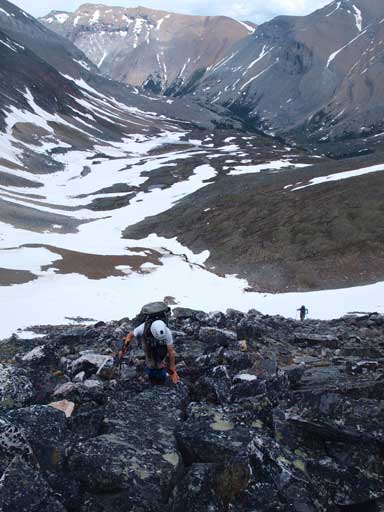 Ben slogging up typical boulders on the NE slope