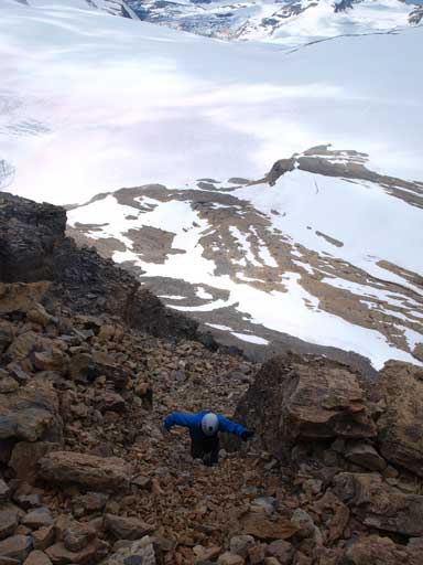 Ben scrambling up the chimney on this part that probably can be rated as a difficult scramble. This is the only break up through this rock band. 