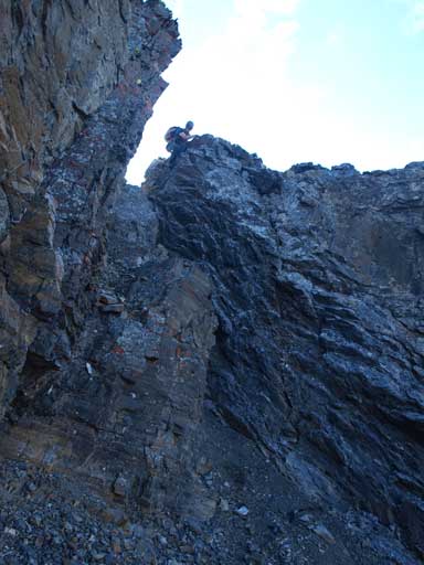 Mike down-climbing a difficult section near the summit of Peak VI