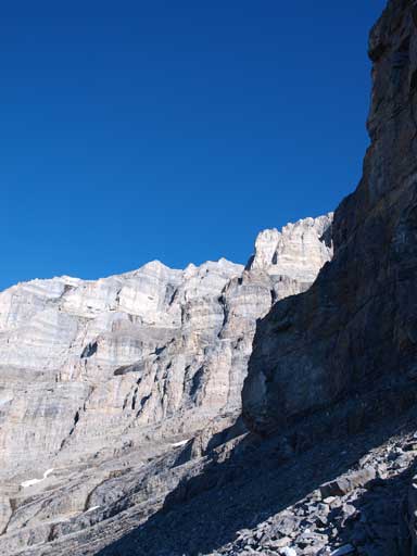 Traversing climber's left to avoid the first imposing cliff band.