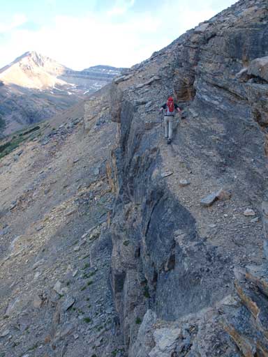 Mike traversing a loose dirt covered exposed ledge. I ascended on climber's right.