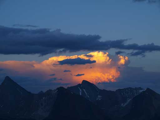 The last sunlight shone on an intense thunderstorm afar. It's been lightning all night long.