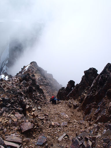 Grant ascending a loose gully after just stepping over an icy spot