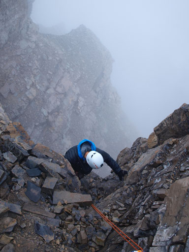 Ben climbing up the 5.3 crux in a blizzard