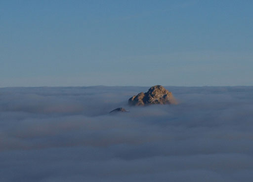 Recondite Peak is the bigger island. Mount Augusta is the tiny one.