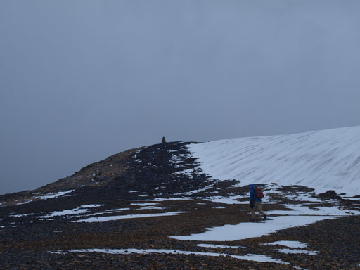 Near the summit, the gigantic cairn is visible