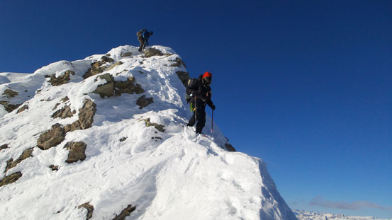 Ben negotiating a narrow section while Eric downclimbing the crux step