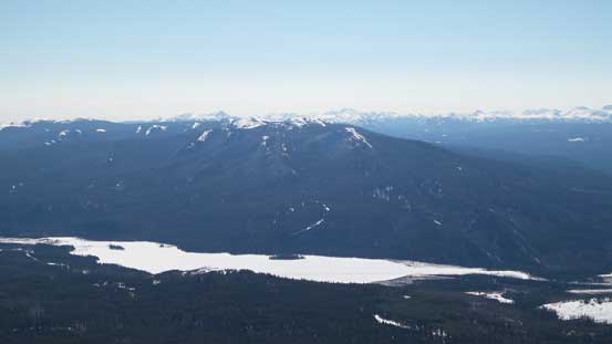 Mount Louie (a treed bump) rises behind Victor Lake and Grande Cache Lake