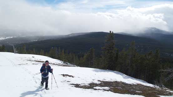 Grant snowshoeing up the summit ridge