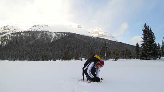 Ferenc strapping his snowshoes on