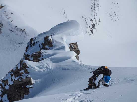 Traversing exposed north facing slopes. Note the cornice ahead. It threatens the entire south facing slope that we'd descend shortly after. Photo by Vern