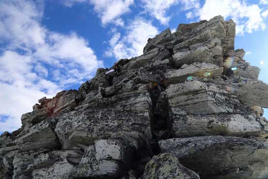 Me scrambling up the summit block. Photo by Ben