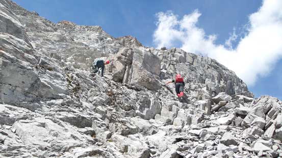 Descending the summit block to access the scree ledge