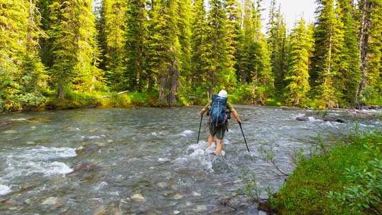 Eric fording the raging Baird Brook