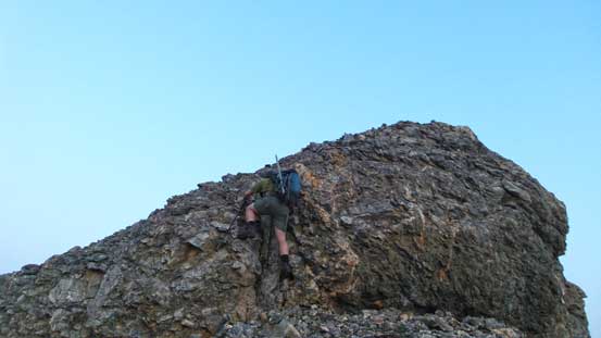 Eric scrambling up an optional rock band on the connecting ridge