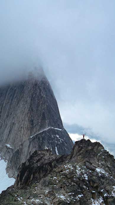 Ferenc on the summit, with the NE Ridge of Bugaboo Spire behind (one of the 50 classics)