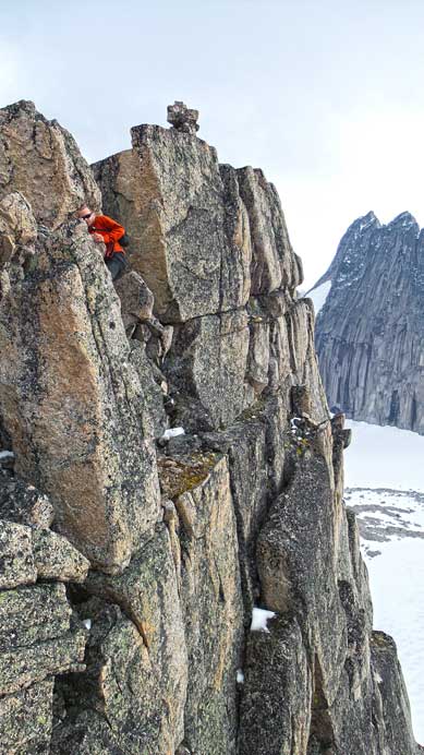 Ben down-climbing the short but exposed chimney near the summit