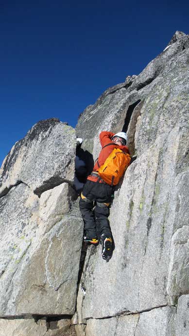 Ben climbing up the awkward right-facing corner.