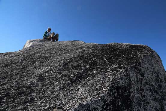 Me sitting on the true true summit. Photo by Ben
