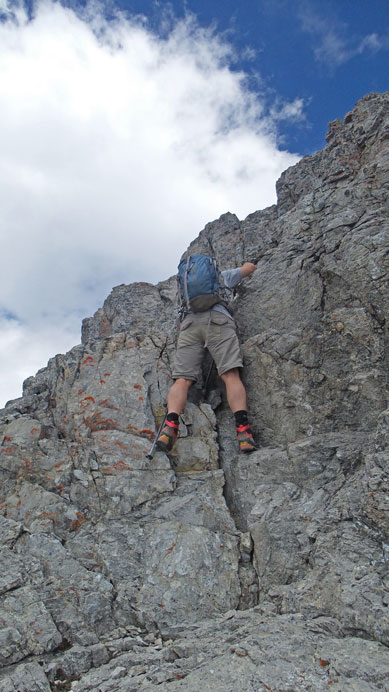 Eric down-climbing a short step near the summit