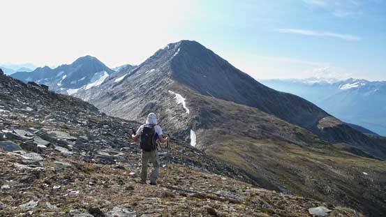 Ben hiking down towards the saddle