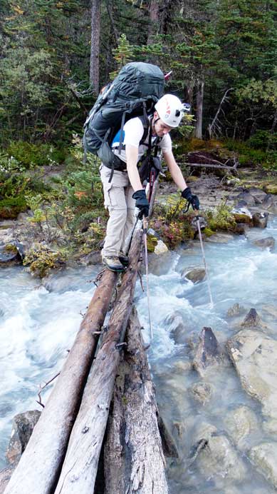Crossing a slippery log on the approach trail