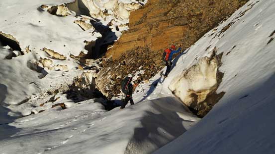 Vern and Ben crossing the huge bergschrund/moat using a snow bridge