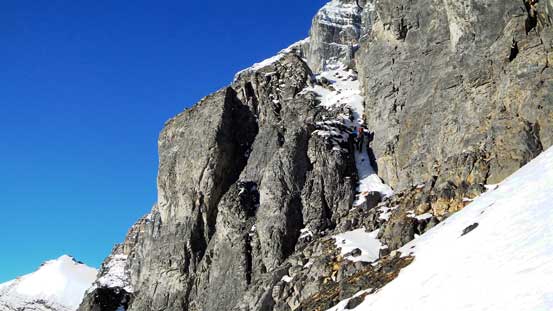 Vern scrambling up the critical chimney on the traversing section.
