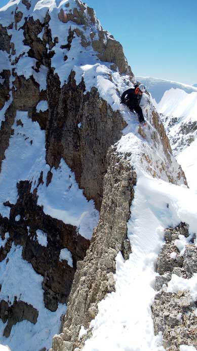 Ben carefully down-climbing just above the crux