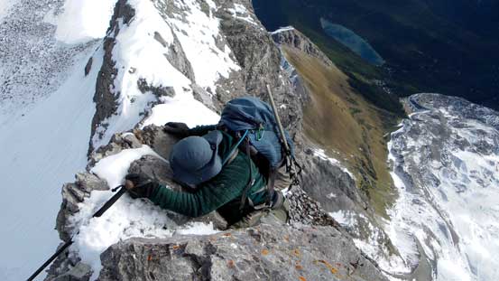 Eric down-climbing an awkward and exposed step off from false summit.